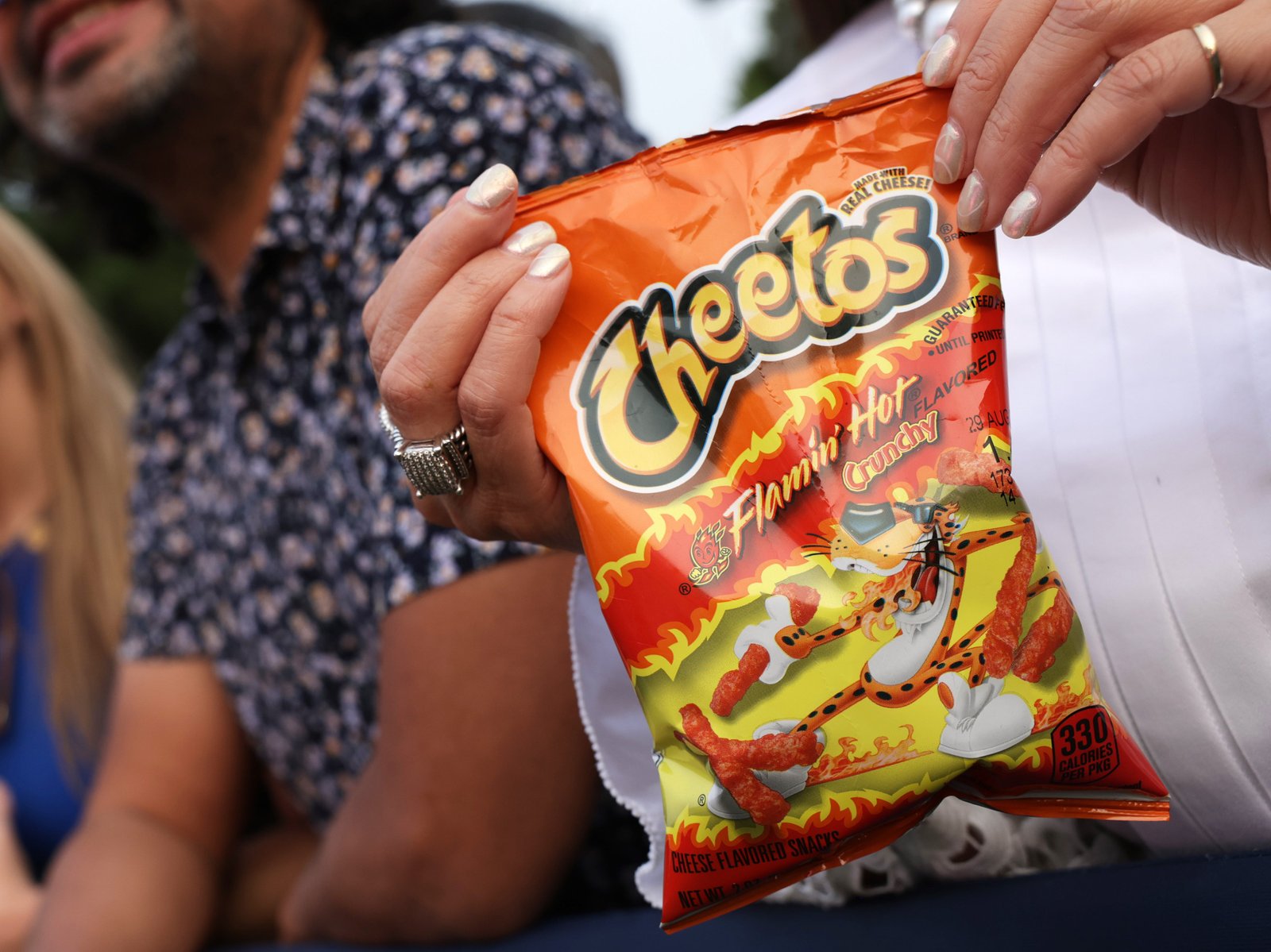 A woman has kept a bag of Flamin 'Hot Cheatos