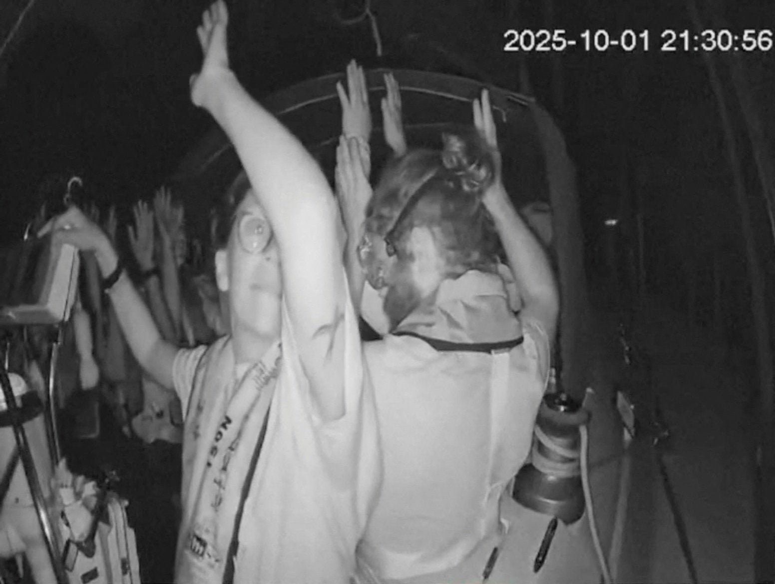 A scrabgab from a live footage video shows the crew of a gaza-bound vessel, is part of the global Sumud Floatilla, put his hands up as they are intercepted by Israeli security forces