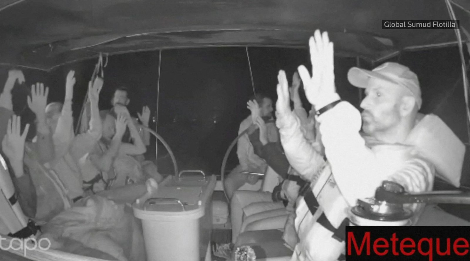 A scrabgab from a live footage video shows the crew of a gaza-bound vessel, is part of the global Sumud Floatilla, put his hands up as they are intercepted by Israeli security forces