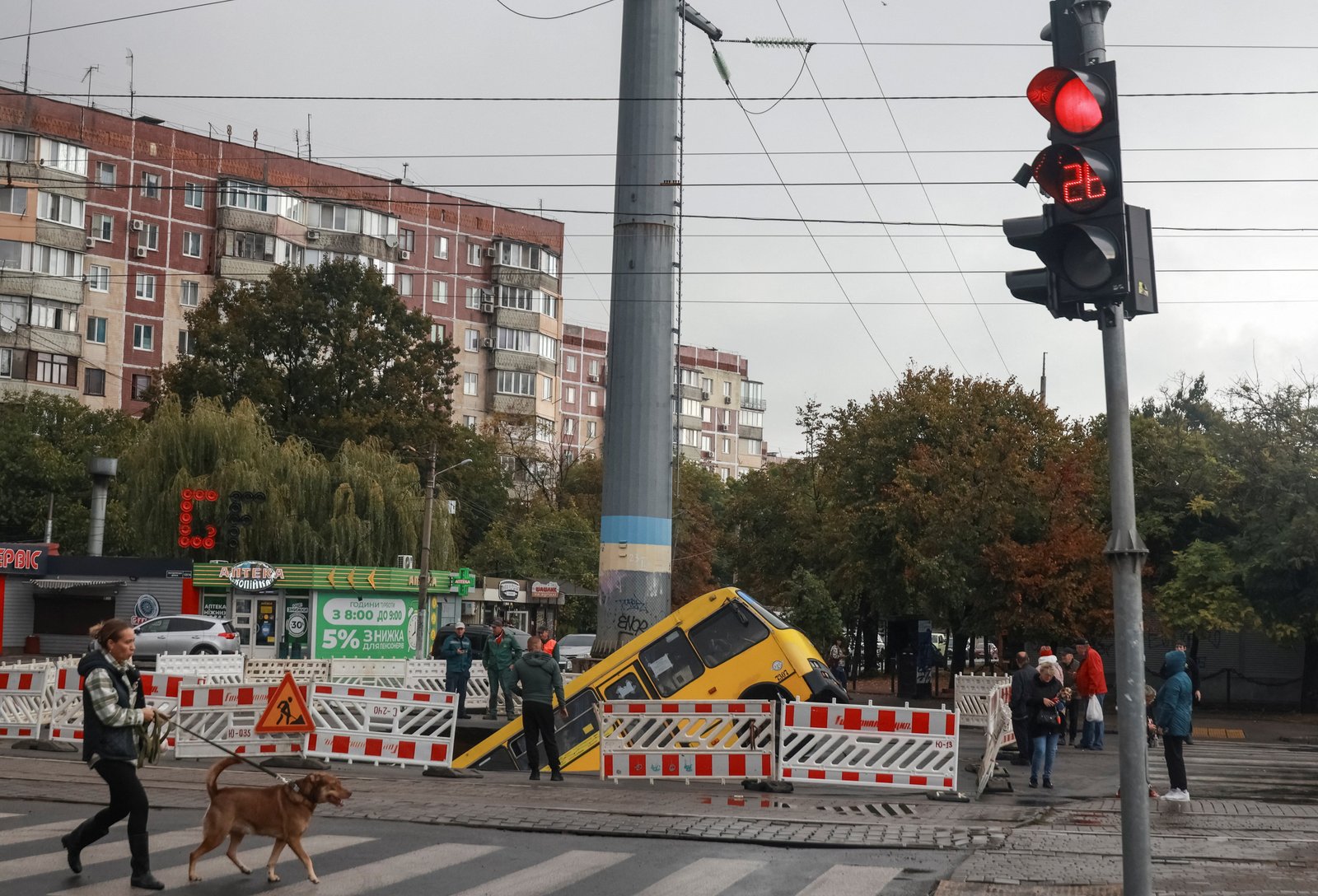 A bus gets trapped in a huge hole that is opened on a road after huge rains in Odessa.