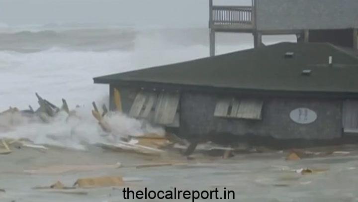 Beach houses fall into the sea as a storm