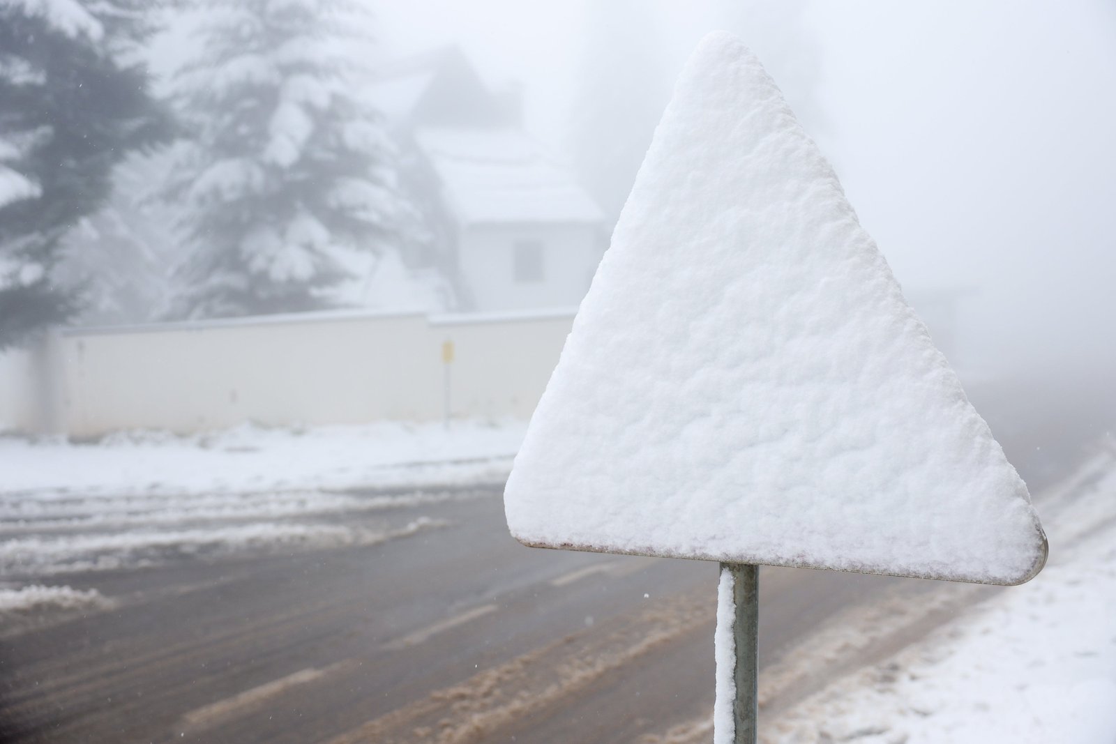 A road symbol is covered with snow during an unexpected snowfall on the mountain Zahorina near Sarajevo, Bosnia, Thursday, Thursday, October 2, 2025. (AP Photo/Armin Durgut)