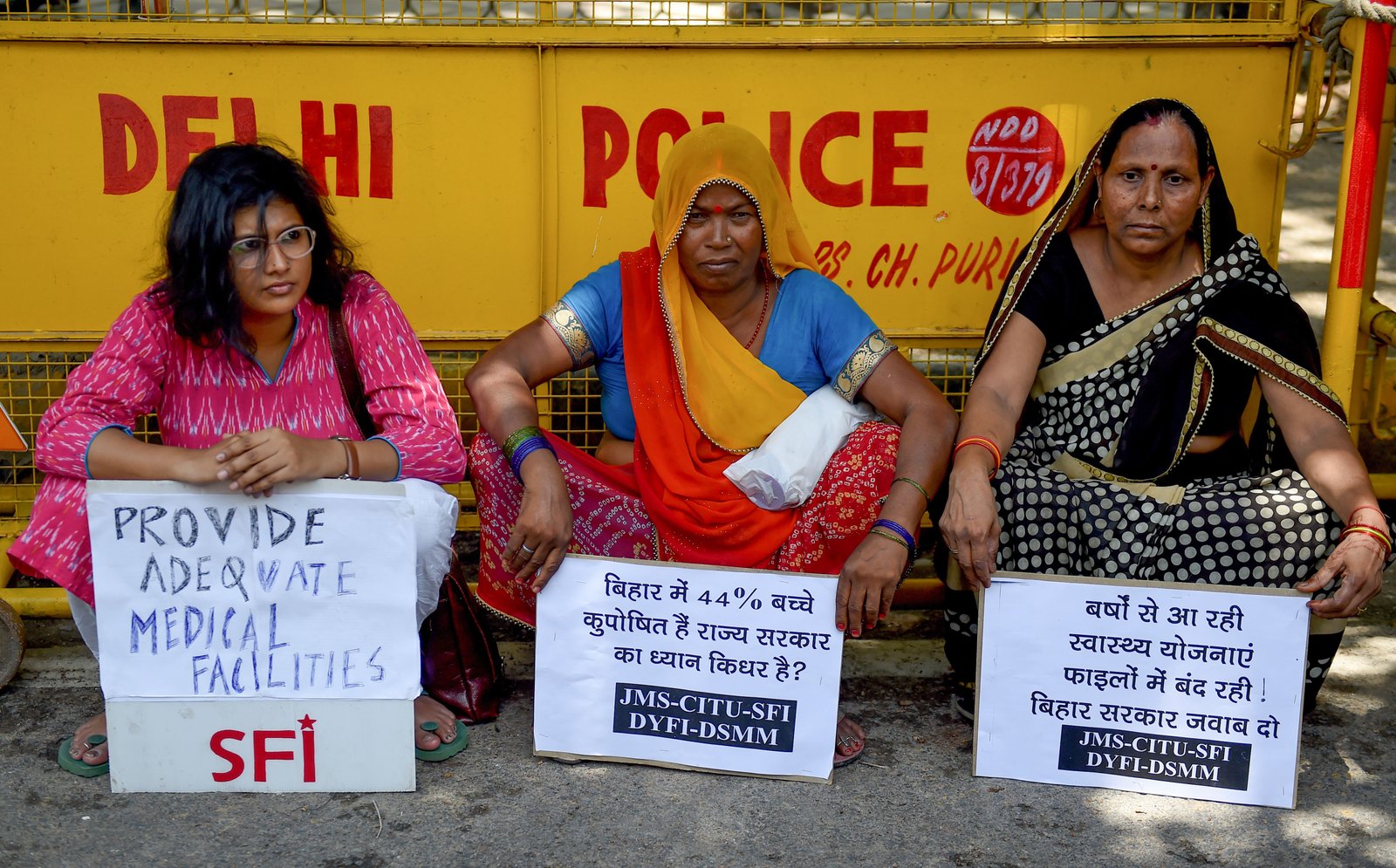 file. Indian women workers seek placards during protest demanding adequate medical facilities