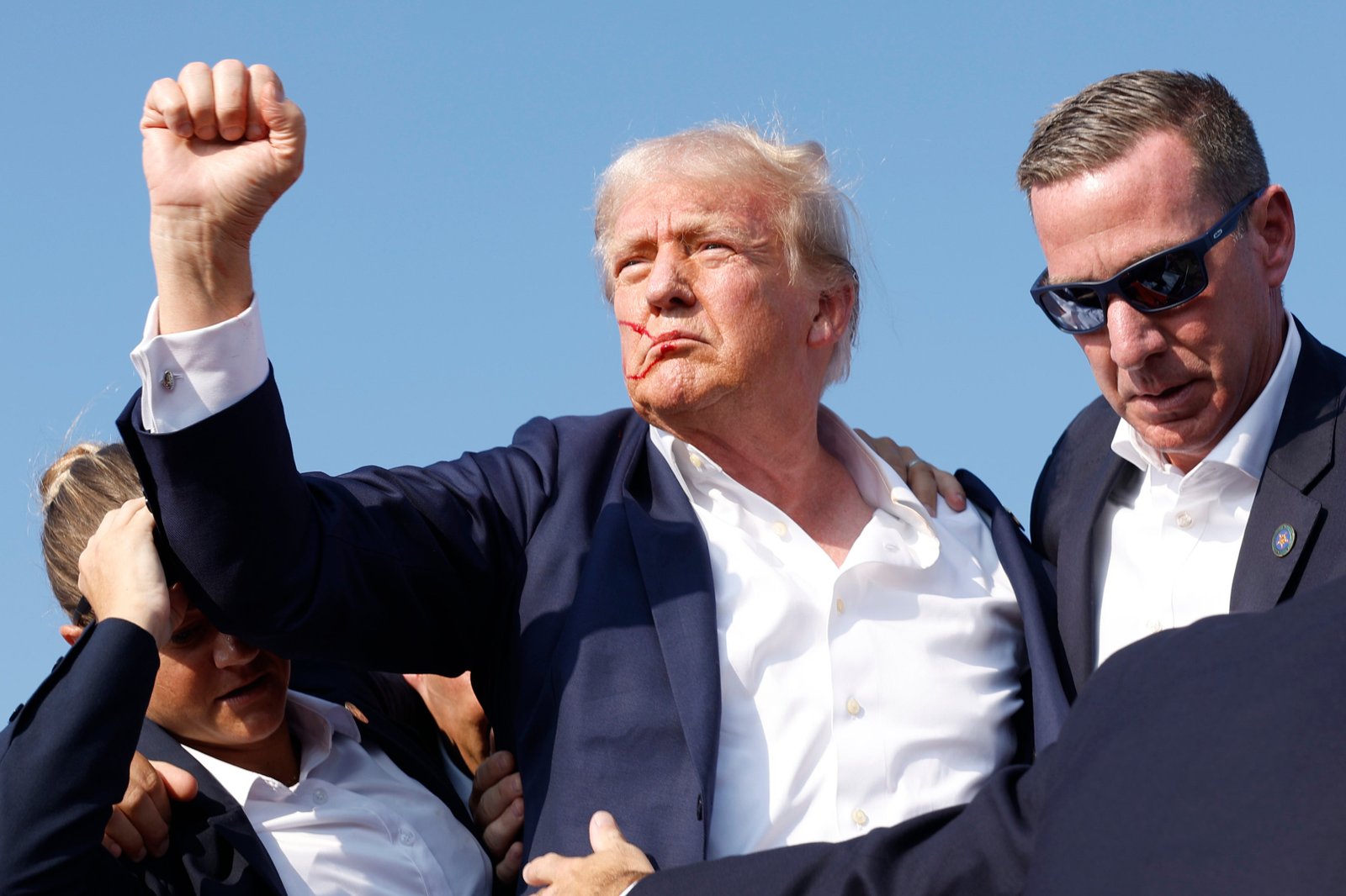 The coin's 'Tales' side resembles this gesture by President Donald Trump, when he was shot in an ear at a rally in Buttler, Pennsylvania in the last summer.