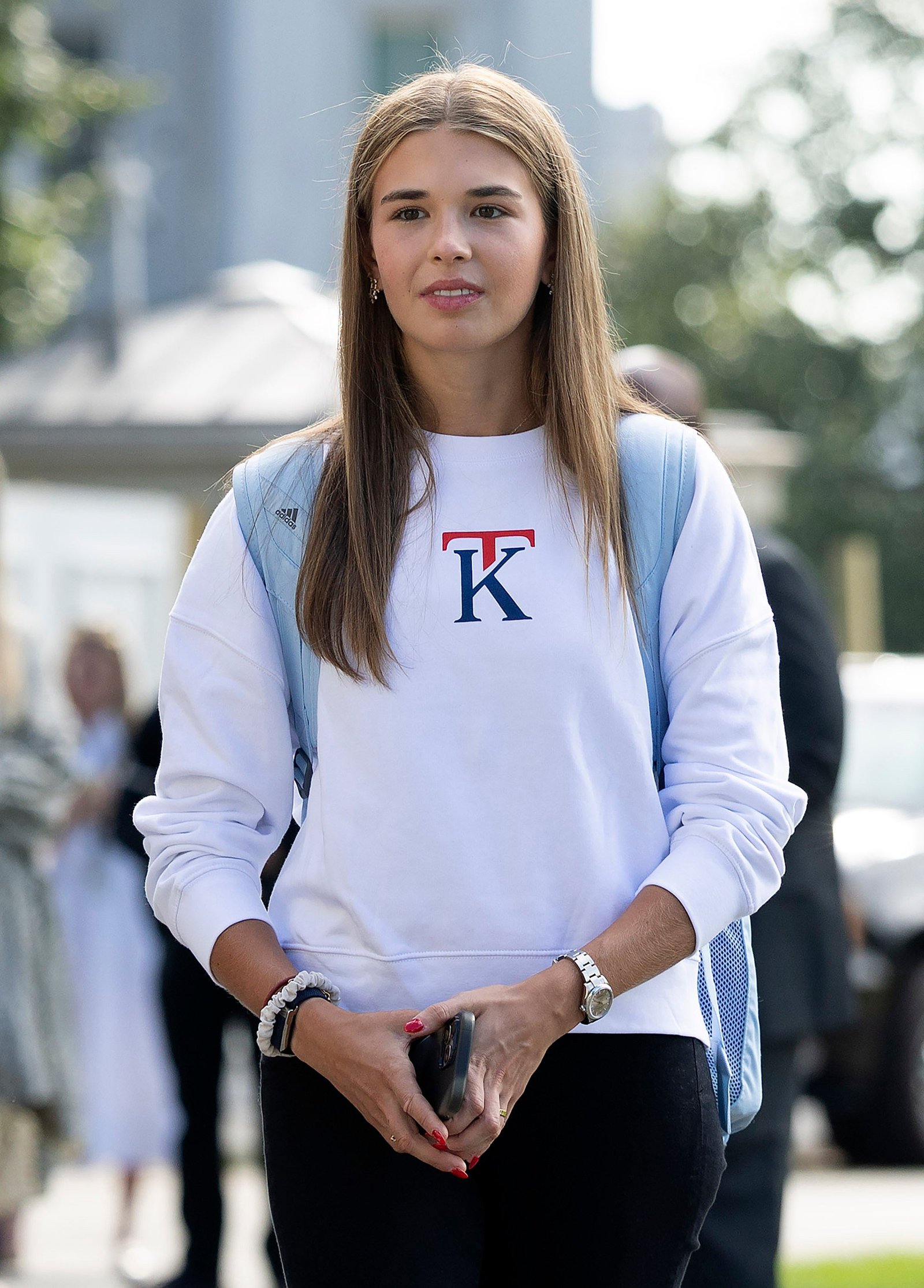 Kai Trump, the granddaughter of US President Donald Trump, departs the White House on Friday, September 26, 2025 playing a sweater from her new clothing line.