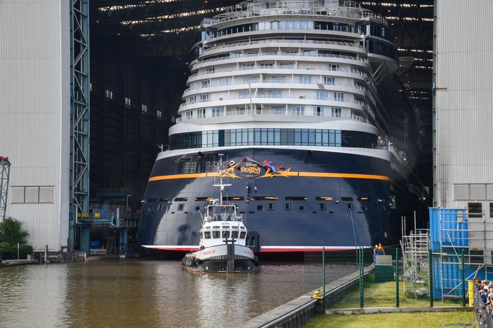 A tugboat draws Disney Destiny from Mayor Werf Dry Dock for its float-out function