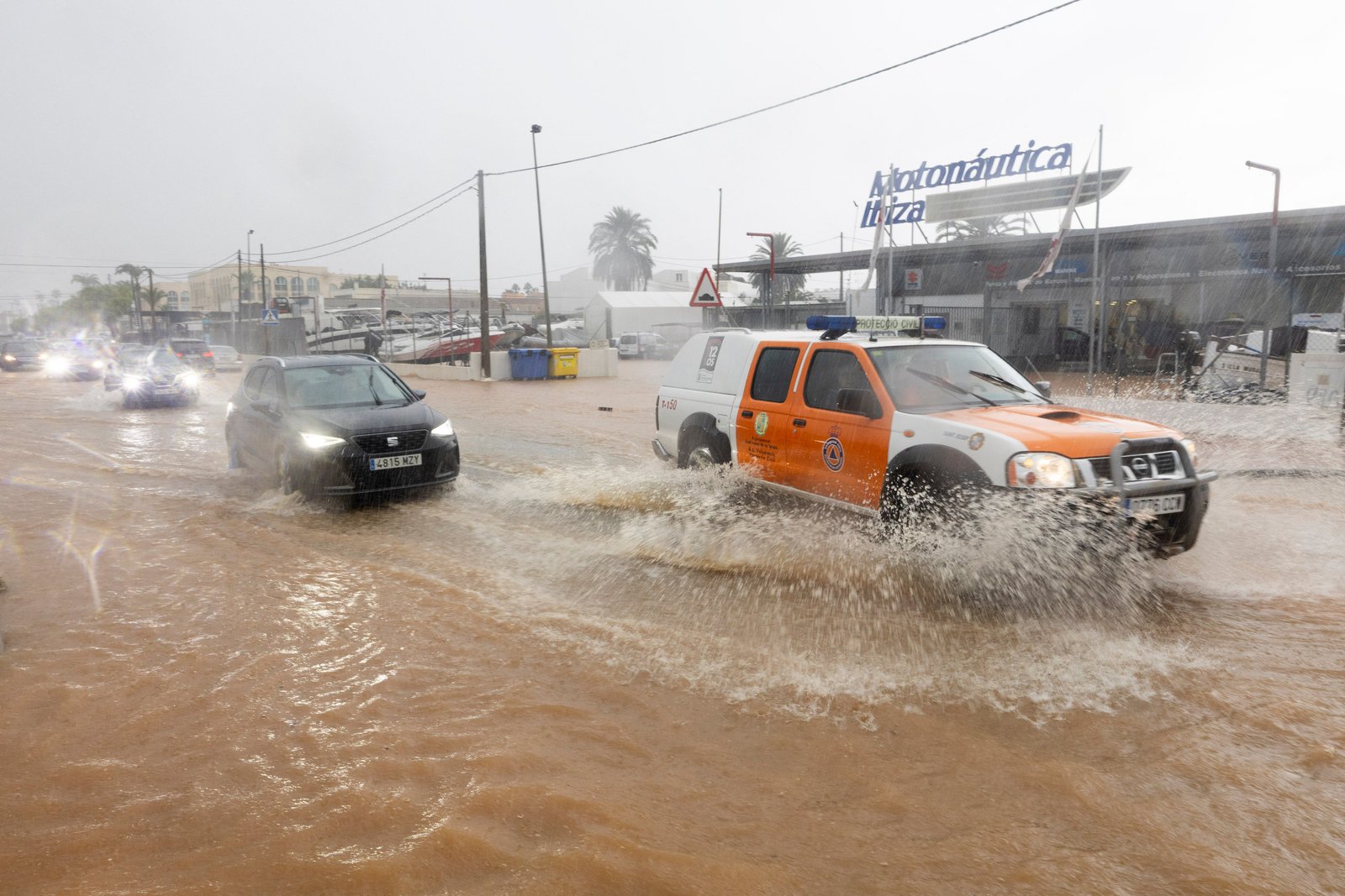 A civil security vehicle drives through a flooded road in Sant Jordan on the island of Ibisa on 30 September 2025