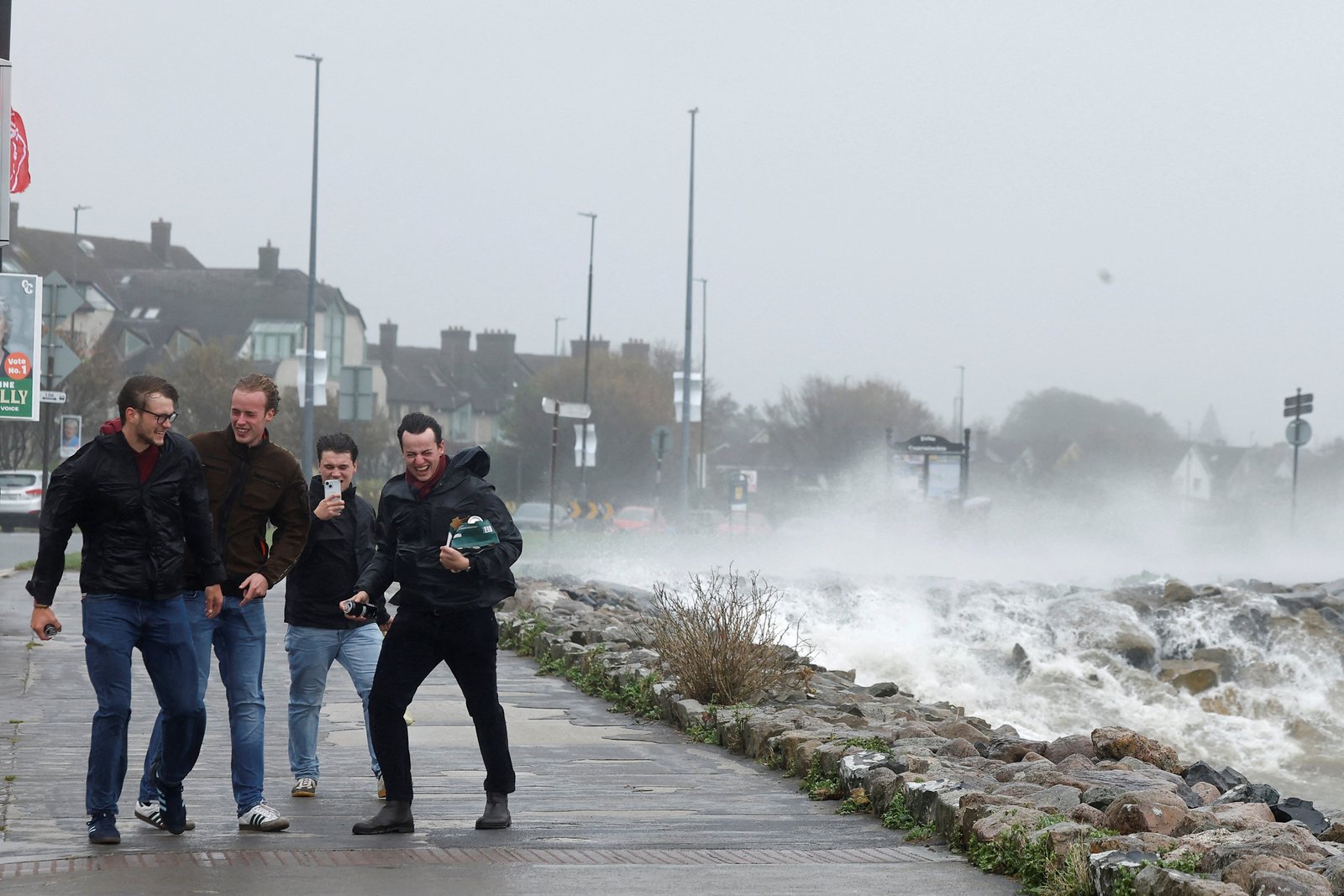People try to walk in GAIL Force wind during Storm Amy in Gaulway, Ireland