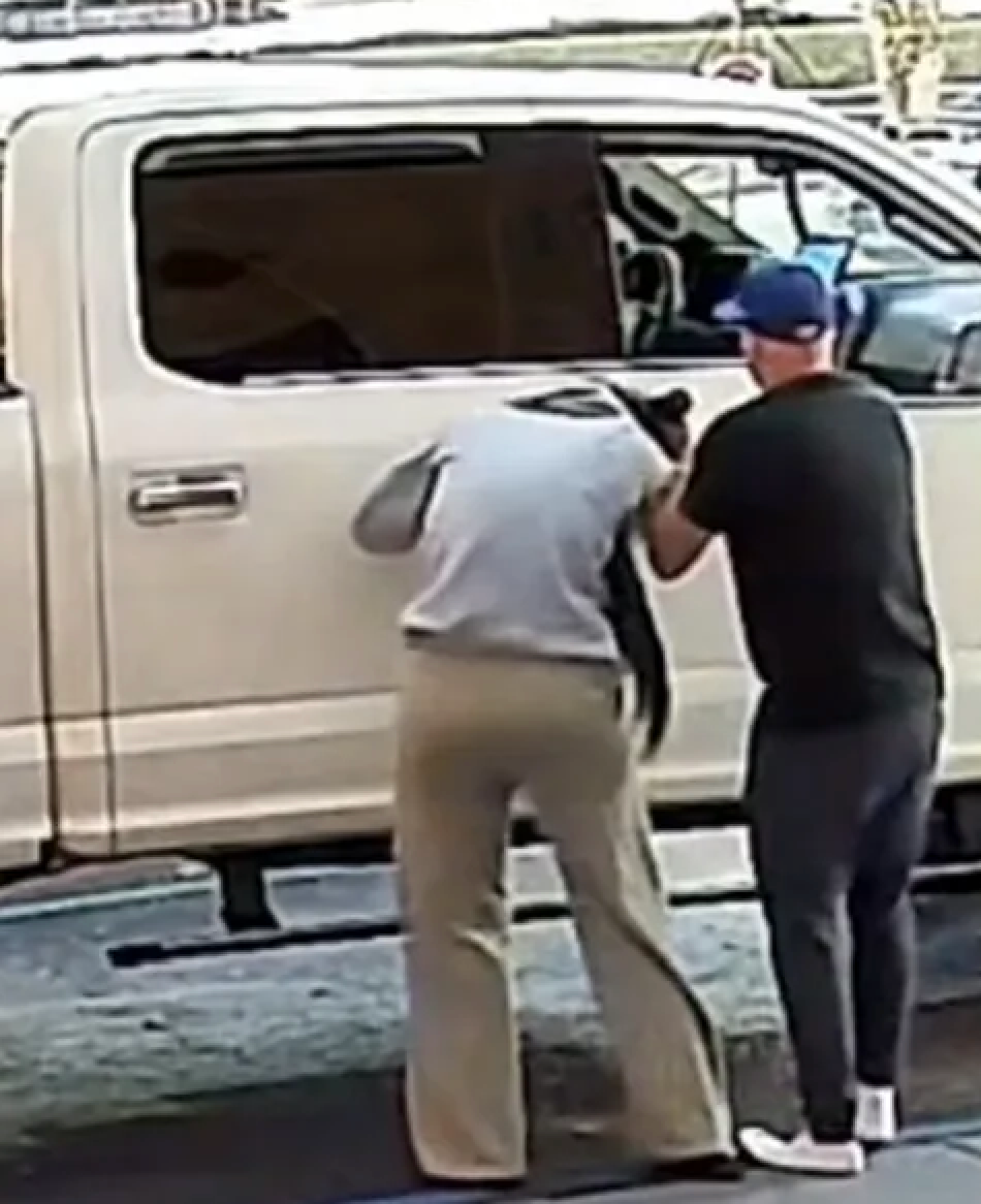 Images from the video show a man wearing all black standing next to a white Ford F-150 and a woman wearing a gray sweatshirt and khaki sweatpants.