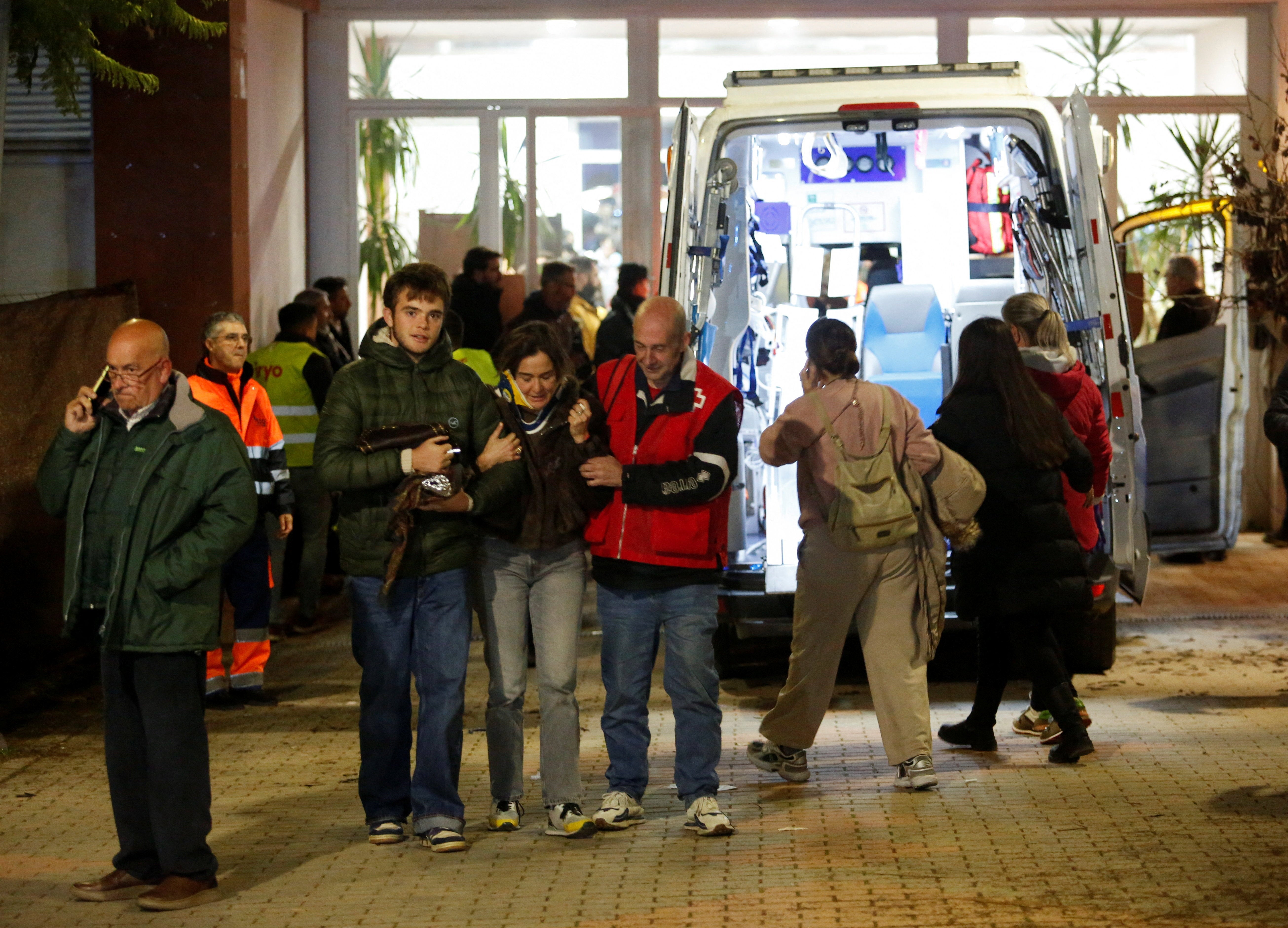 A man assists a woman affected by a fatal train derailment after a high-speed train derailed and collided with another oncoming train near Cordoba, Spain. Other victims were transferred to the municipality of Caserta in the town of Adamus for treatment.
