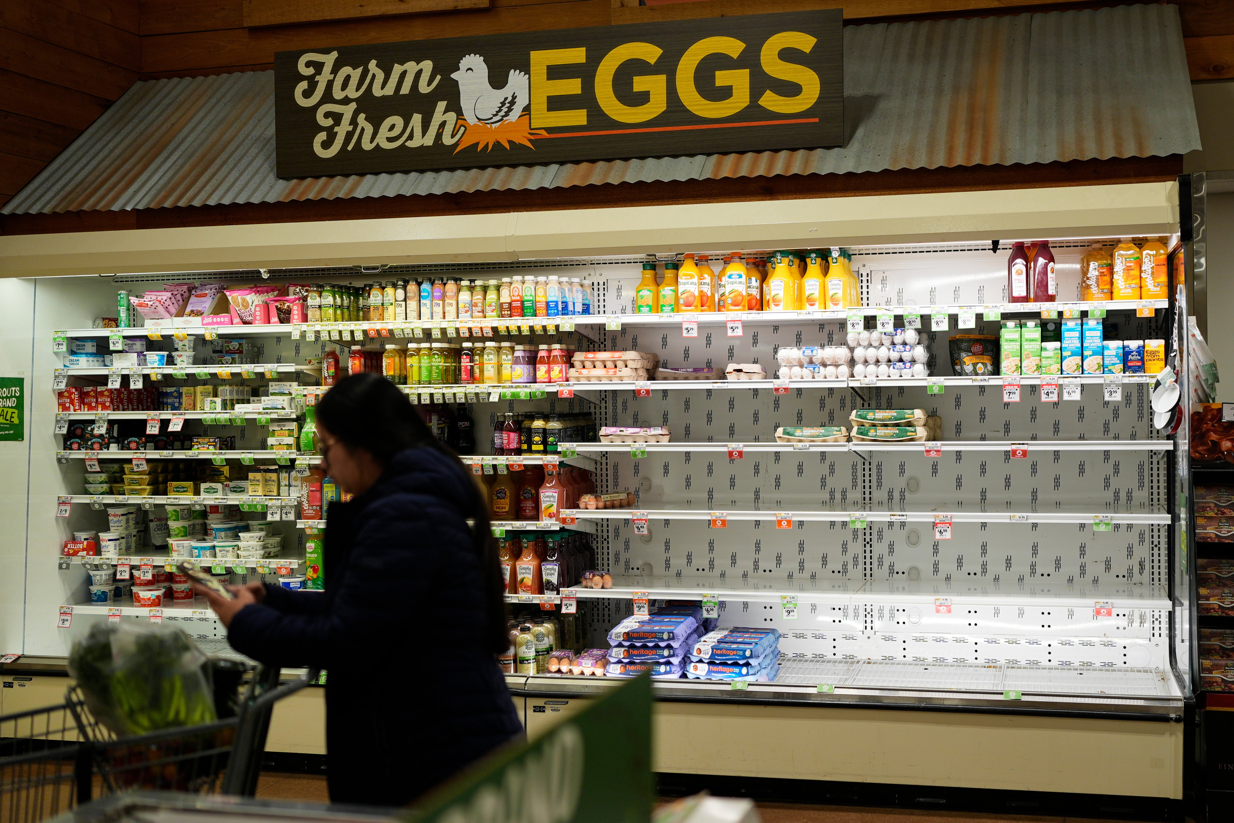 A customer walks by empty shelves before a winter storm in Nashville, Tennessee