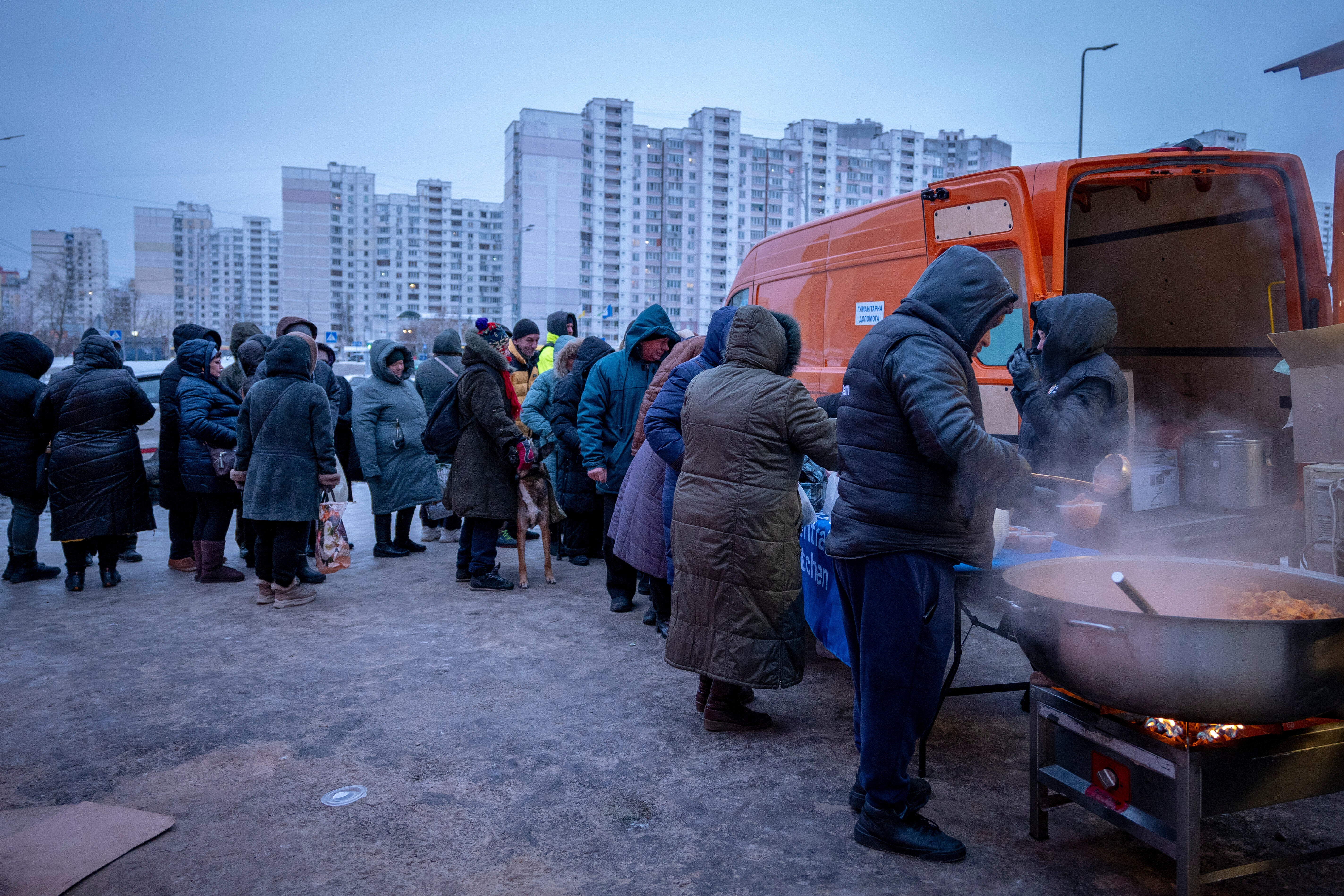 People line up to receive free hot meals in Kiev on Friday