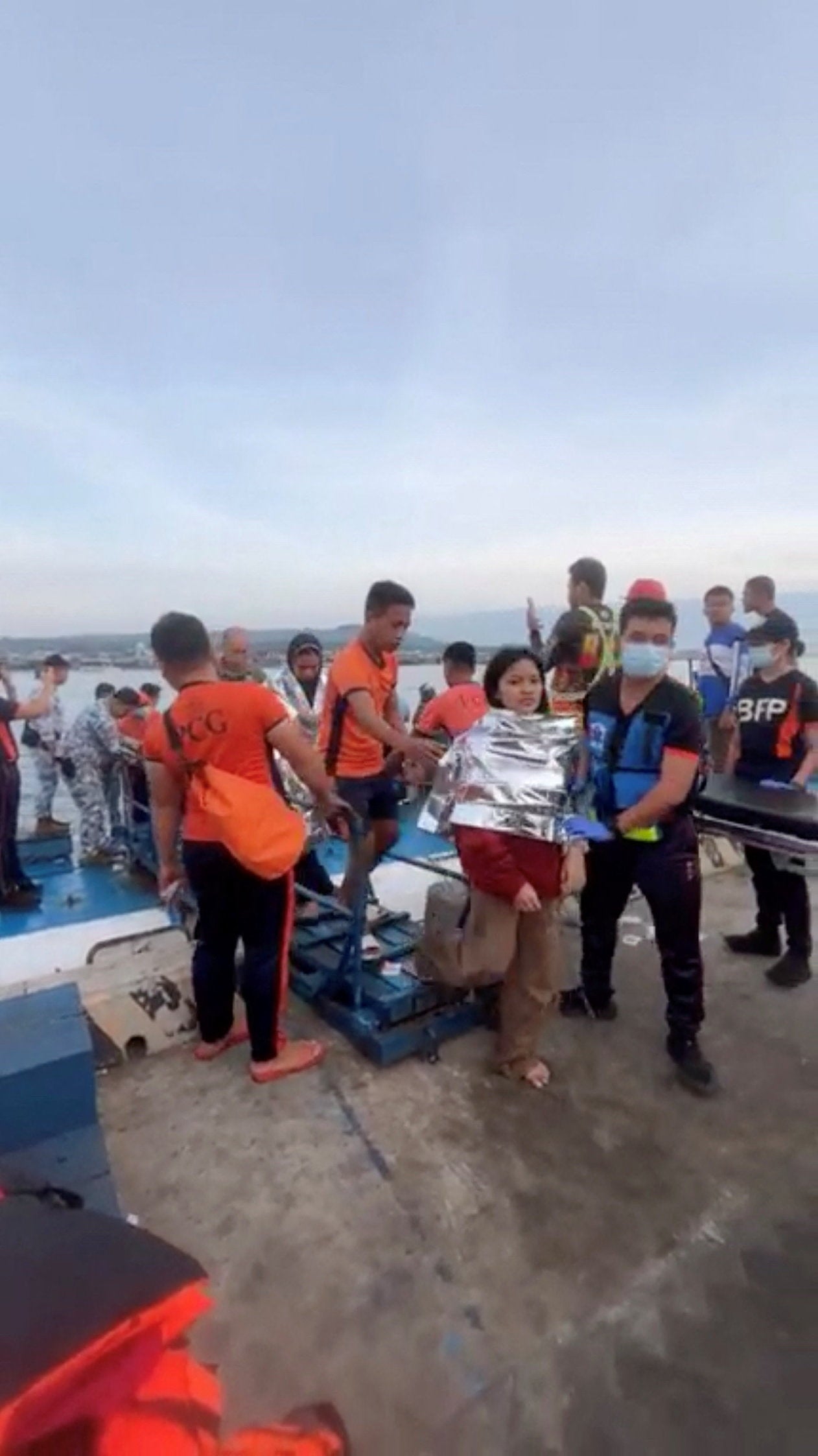 Emergency workers assist victims as they arrive in Port Isabela, Basilan province