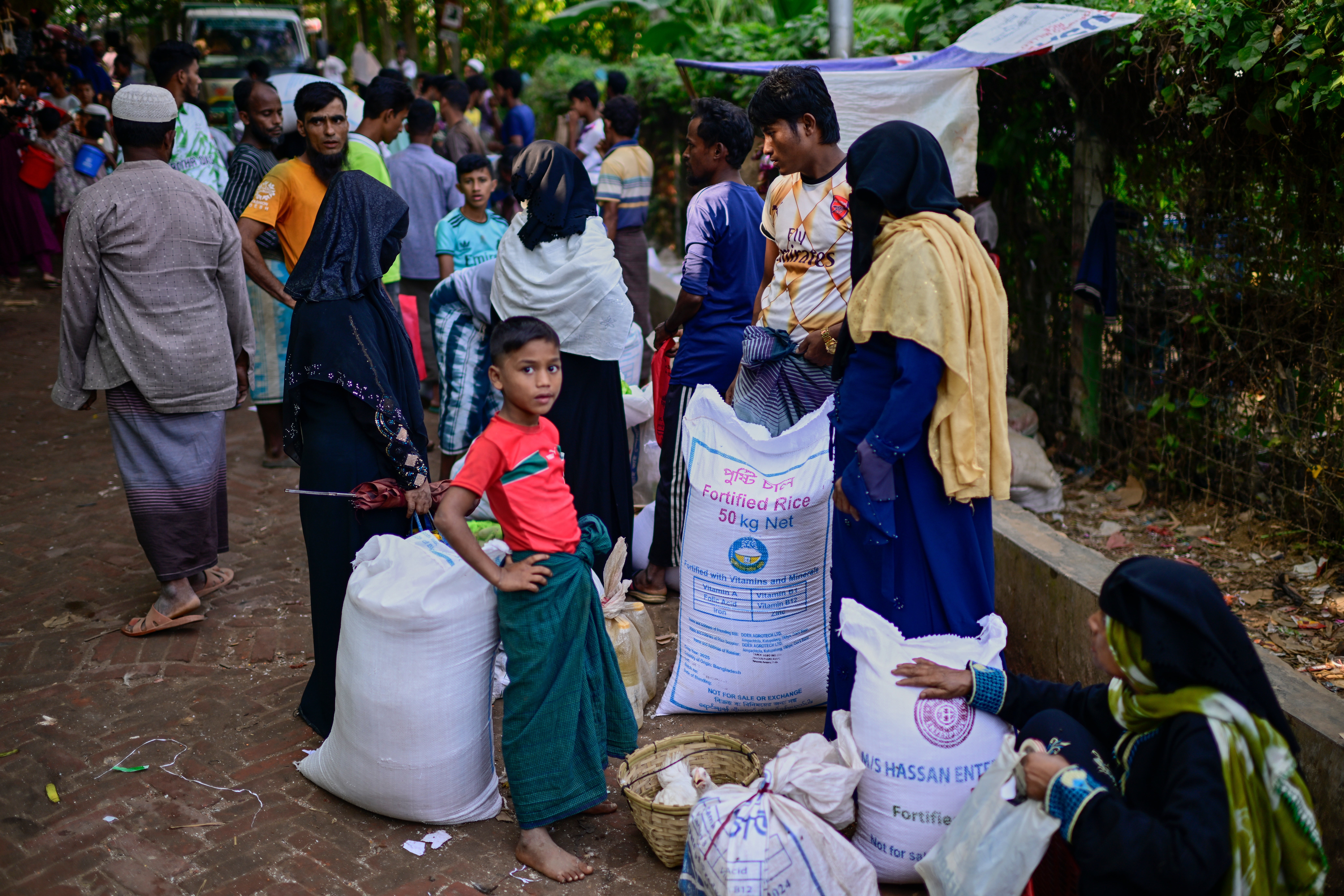 Rohingya refugees wait for food rations at a refugee camp in Bangladesh in November last year