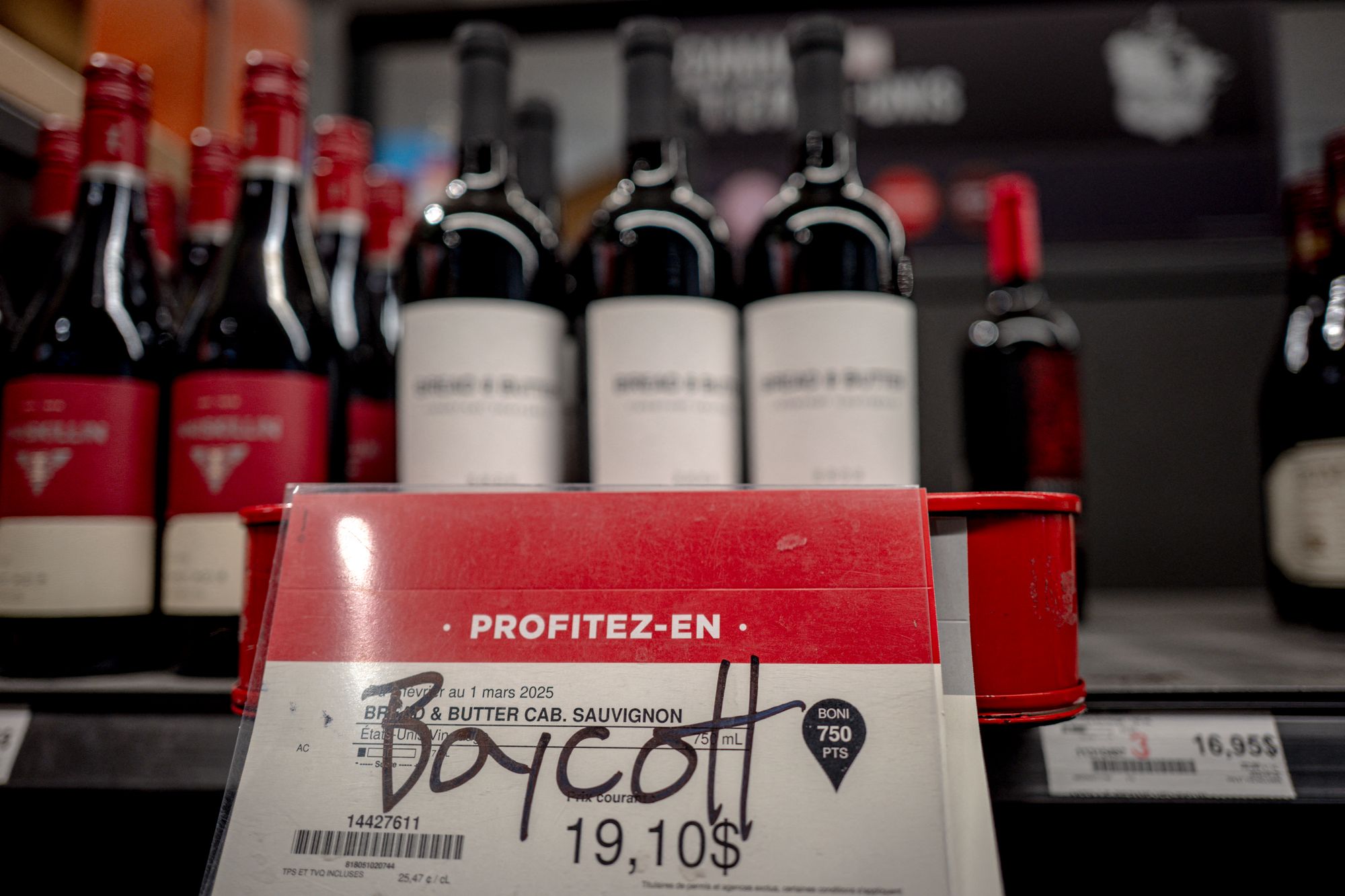 Graffiti at a liquor store in Montreal, Canada calls for a boycott of American wine