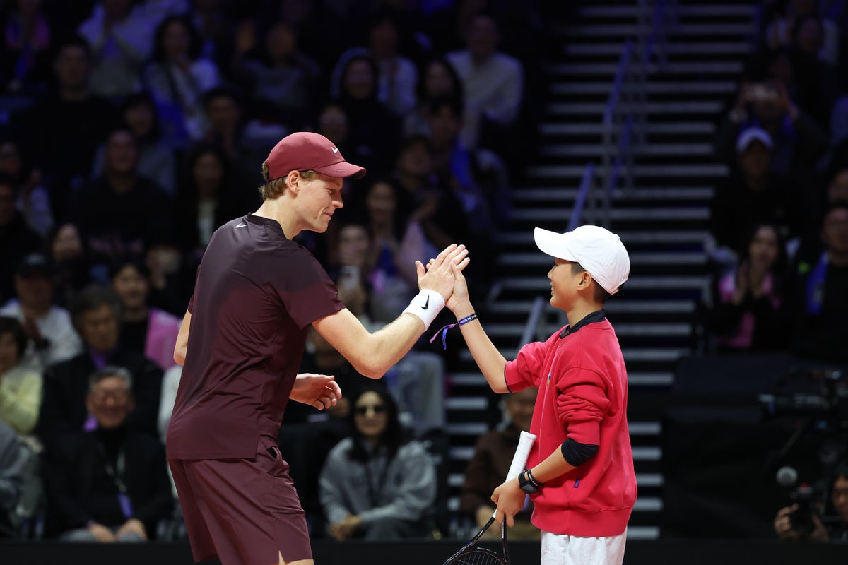 Jannik Sinner hands racket to young fan during straight sets loss to Carlos Alcaraz