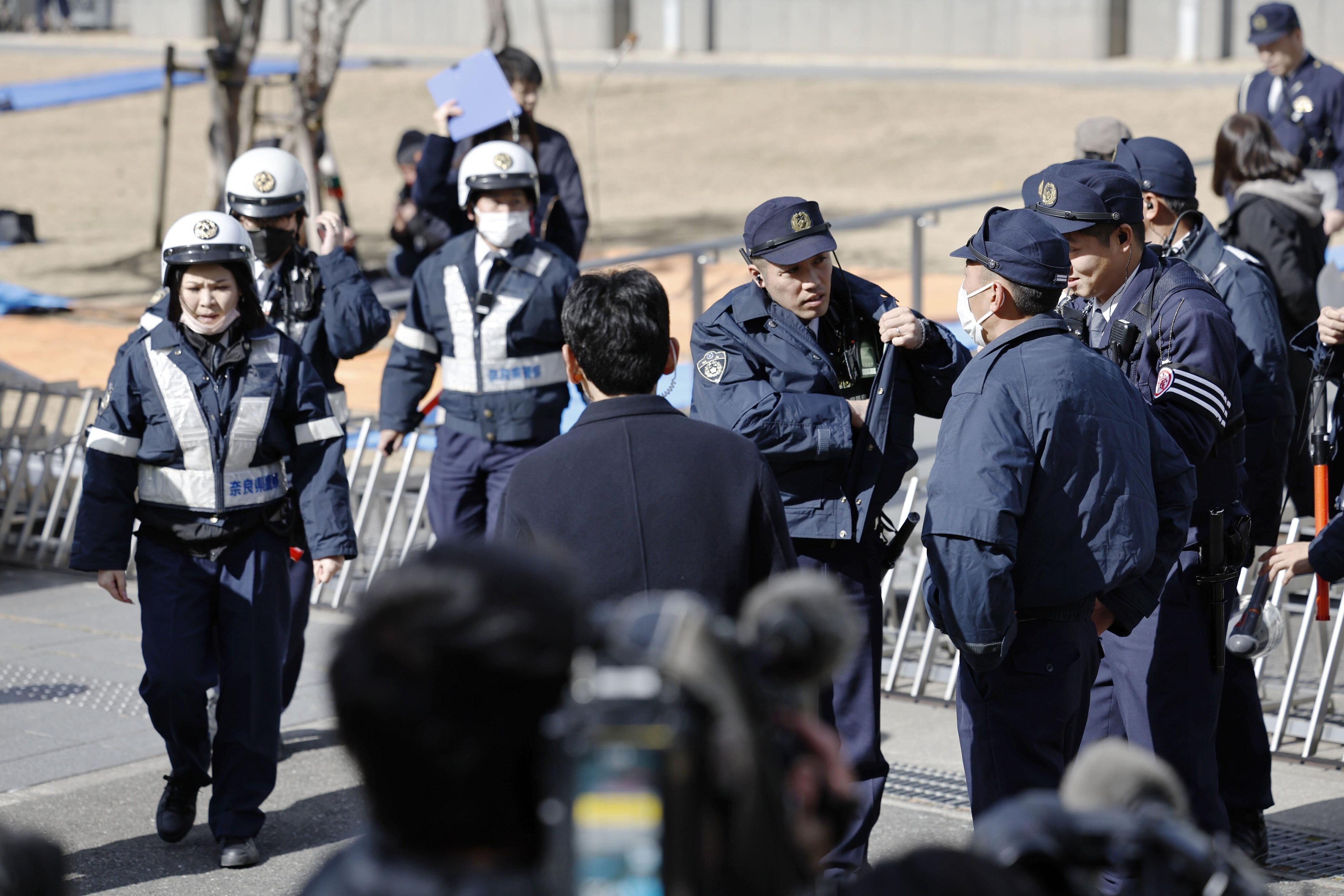 Police stand guard outside the Nara District Court awaiting the verdict against Tetsuya Yamagami. Tetsuya Yamagami is accused of shooting former Japanese Prime Minister Shinzo Abe in Nara.