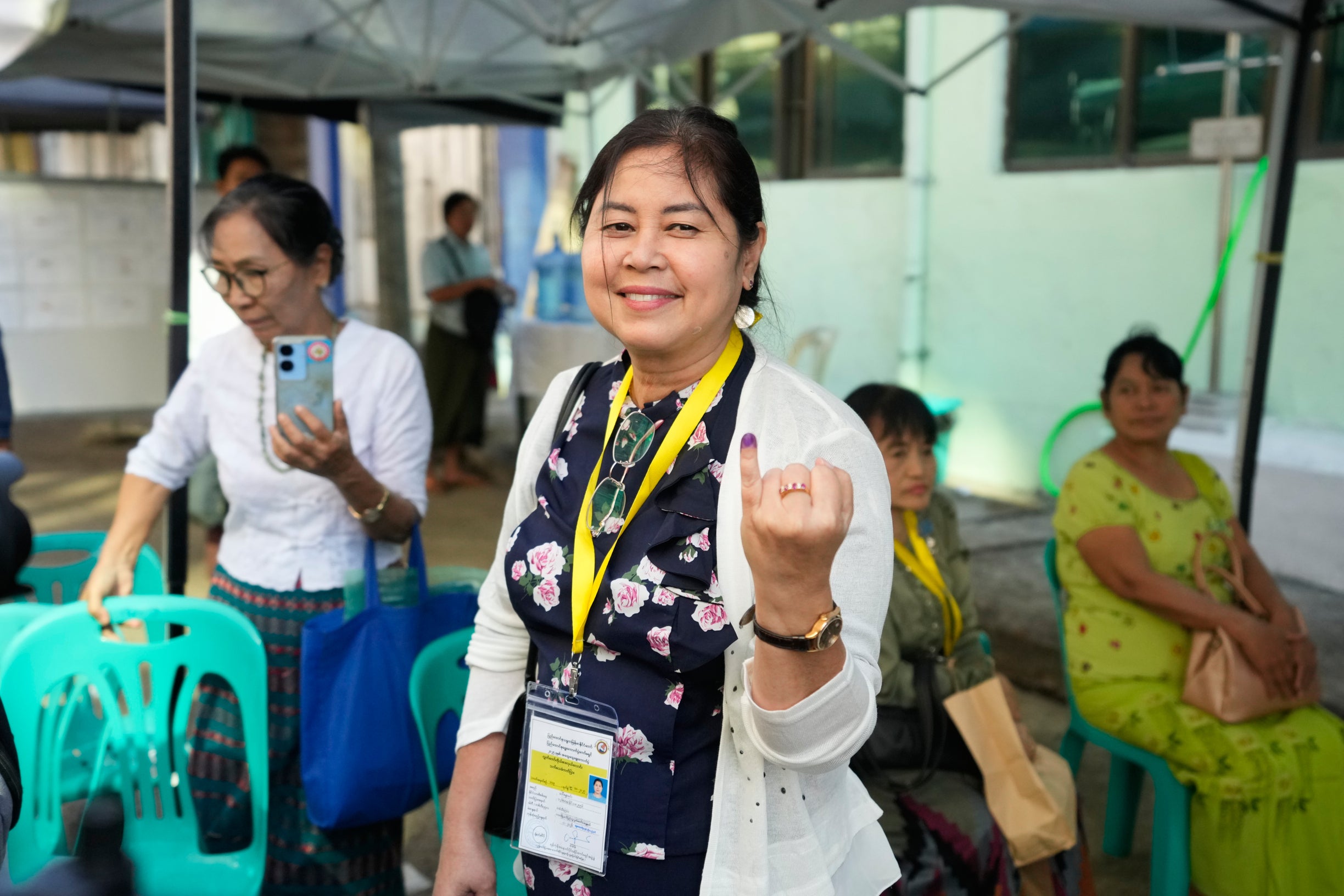 Sandar Min, a former lawmaker and independent candidate for ousted leader Aung San Suu Kyi's National League for Democracy party, shows her tattooed finger after casting her vote at a polling station in Yangon, Myanmar, on January 11