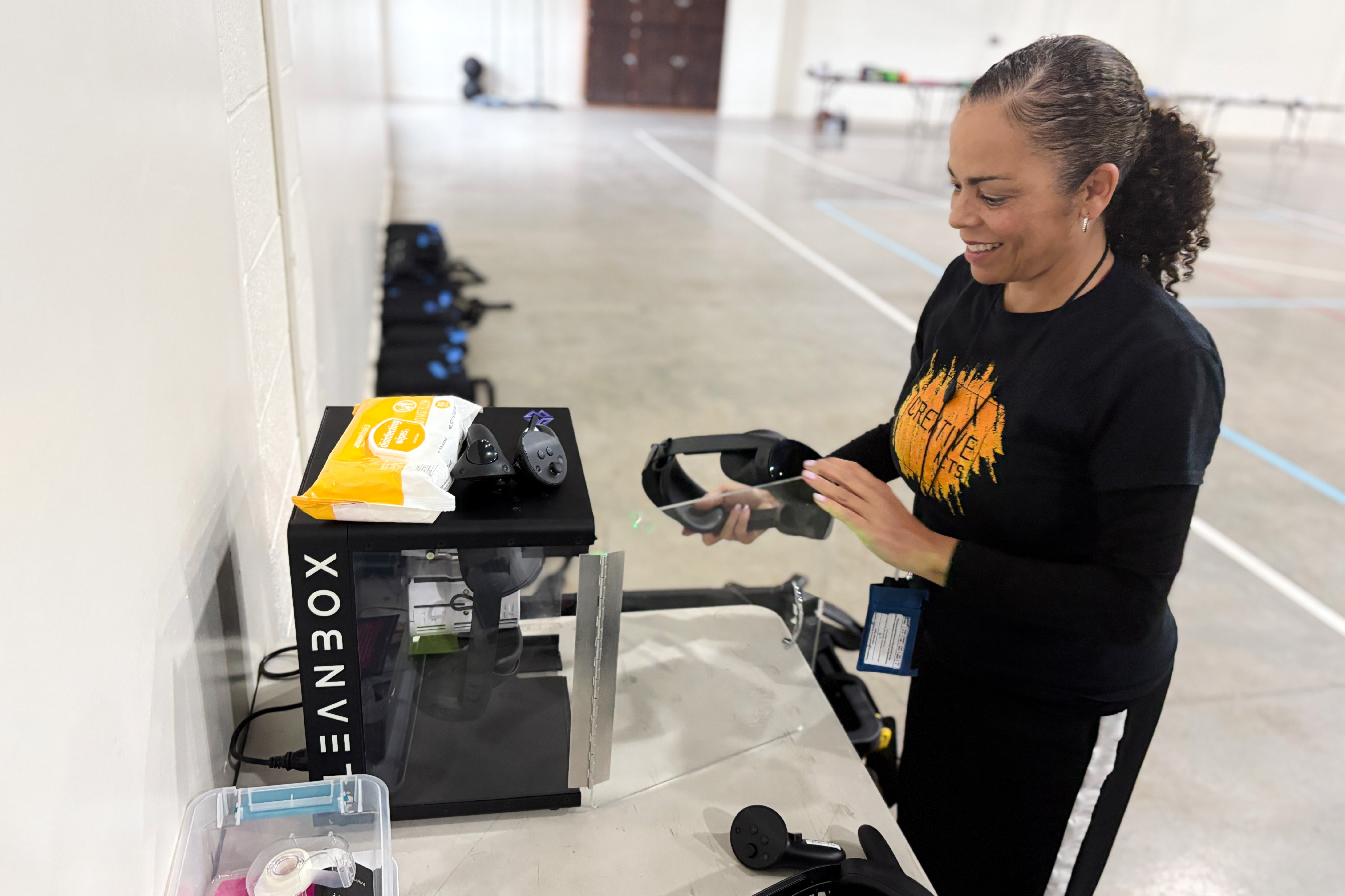 Creative Acts co-founder Sabra Williams cleans a virtual reality headset inside Chowchilla Valley State Prison on December 11, 2025 in California. (AP Photo/Haven Daley)
