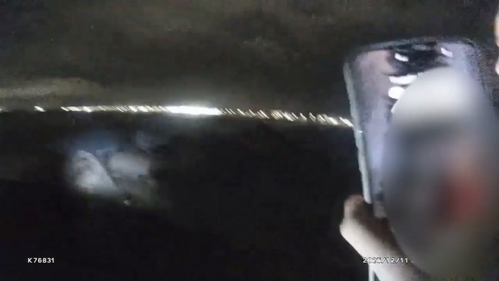 Quick-thinking police officers form human chain to rescue woman from sea