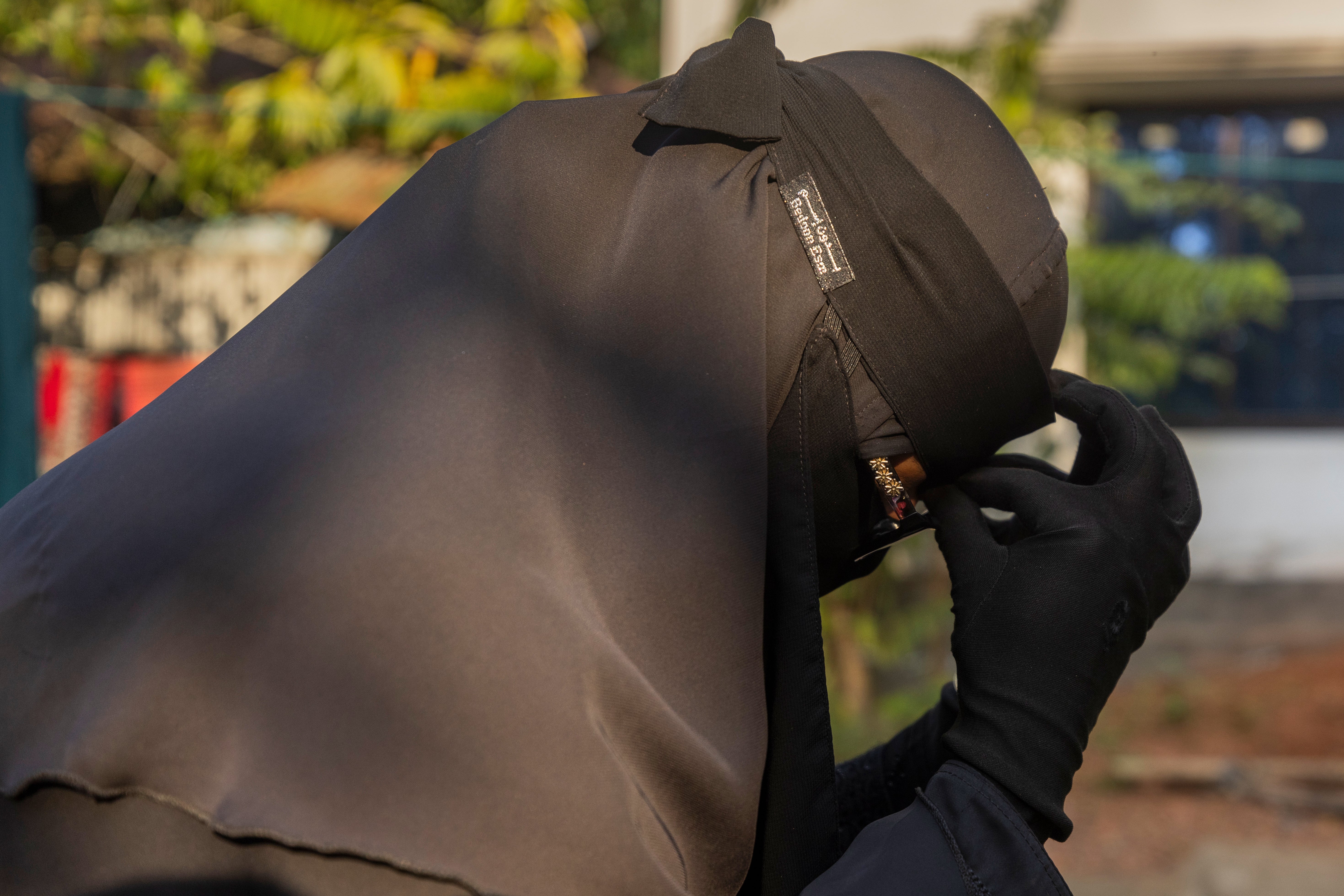 Salma Akdar, 28, who has not heard from her husband Ajgar Hussein, 40, for months, reacts as she sits in Lakshmipur, Bangladesh, Dec. 10, 2025. (AP Photo/Rajib Dhar)