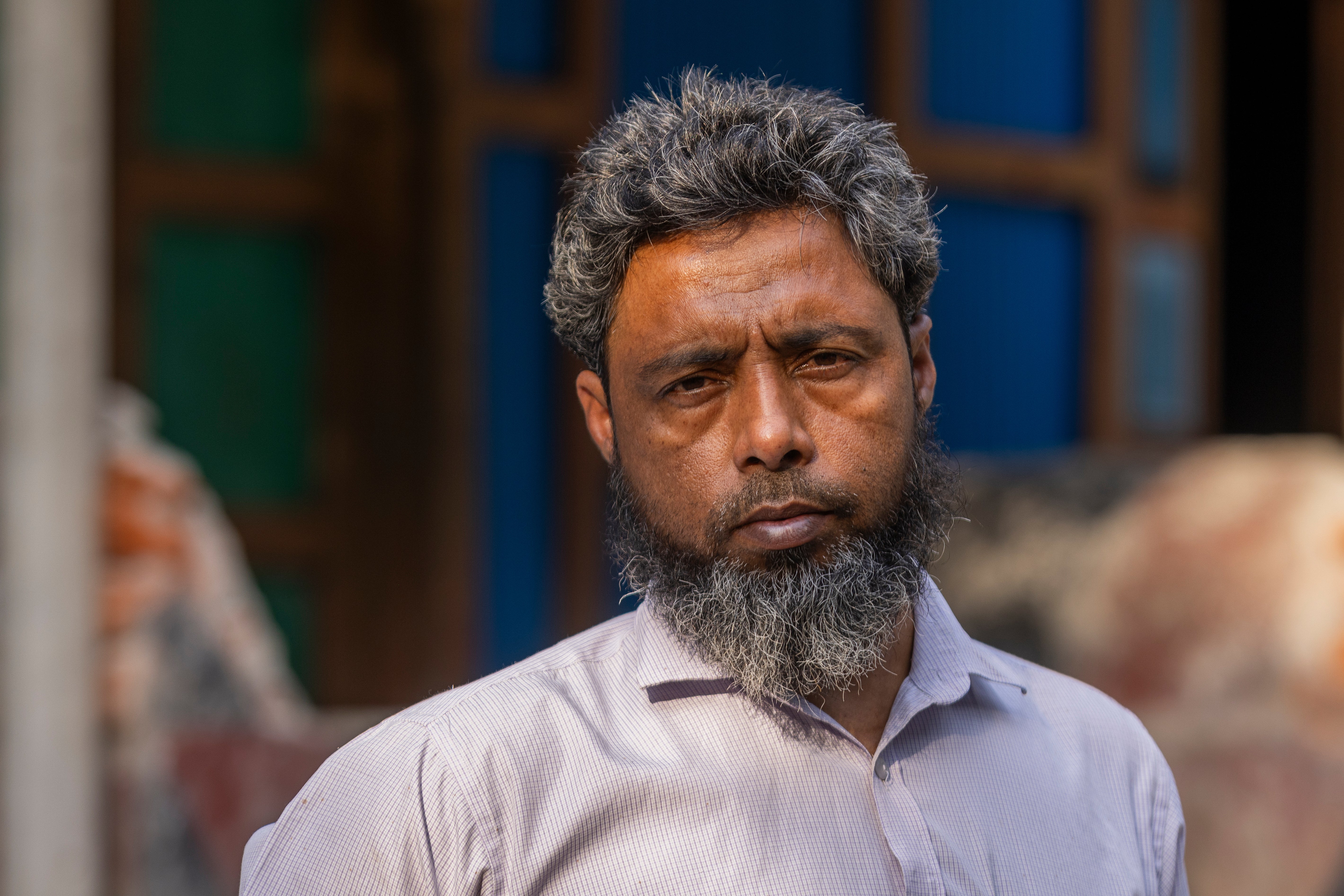 Mohammed Siraj, the father of Sajjad, 20, who was killed after being taken to fight in Russia, poses for a portrait at his home in Lakshmipur, Bangladesh, Dec. 10, 2025. (AP Photo/Rajib Dhar)