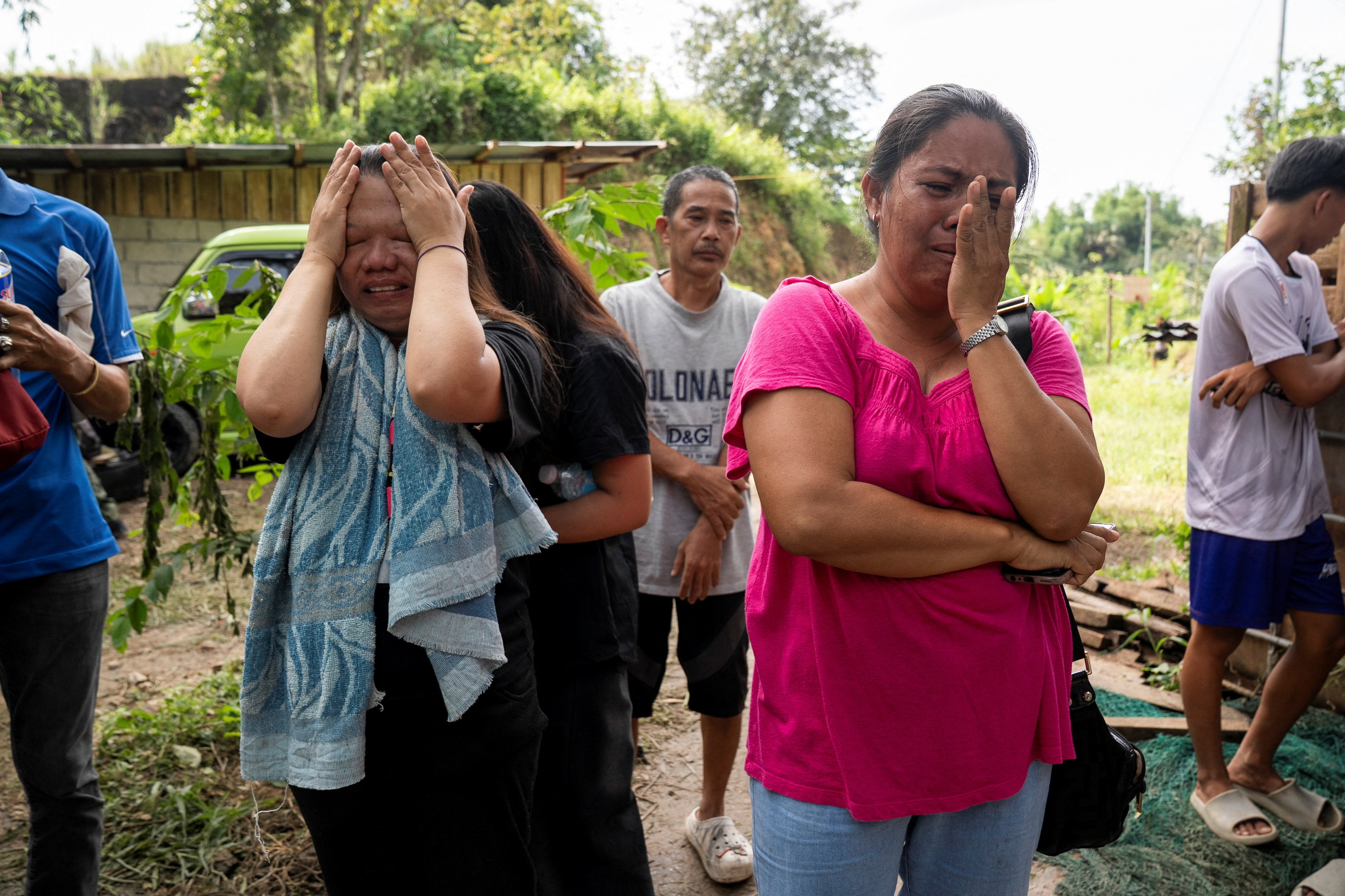 Families and relatives of missing persons react as rescuers conduct rescue operations at the collapsed landfill in Binalife, Cebu, Philippines, January 11, 2026