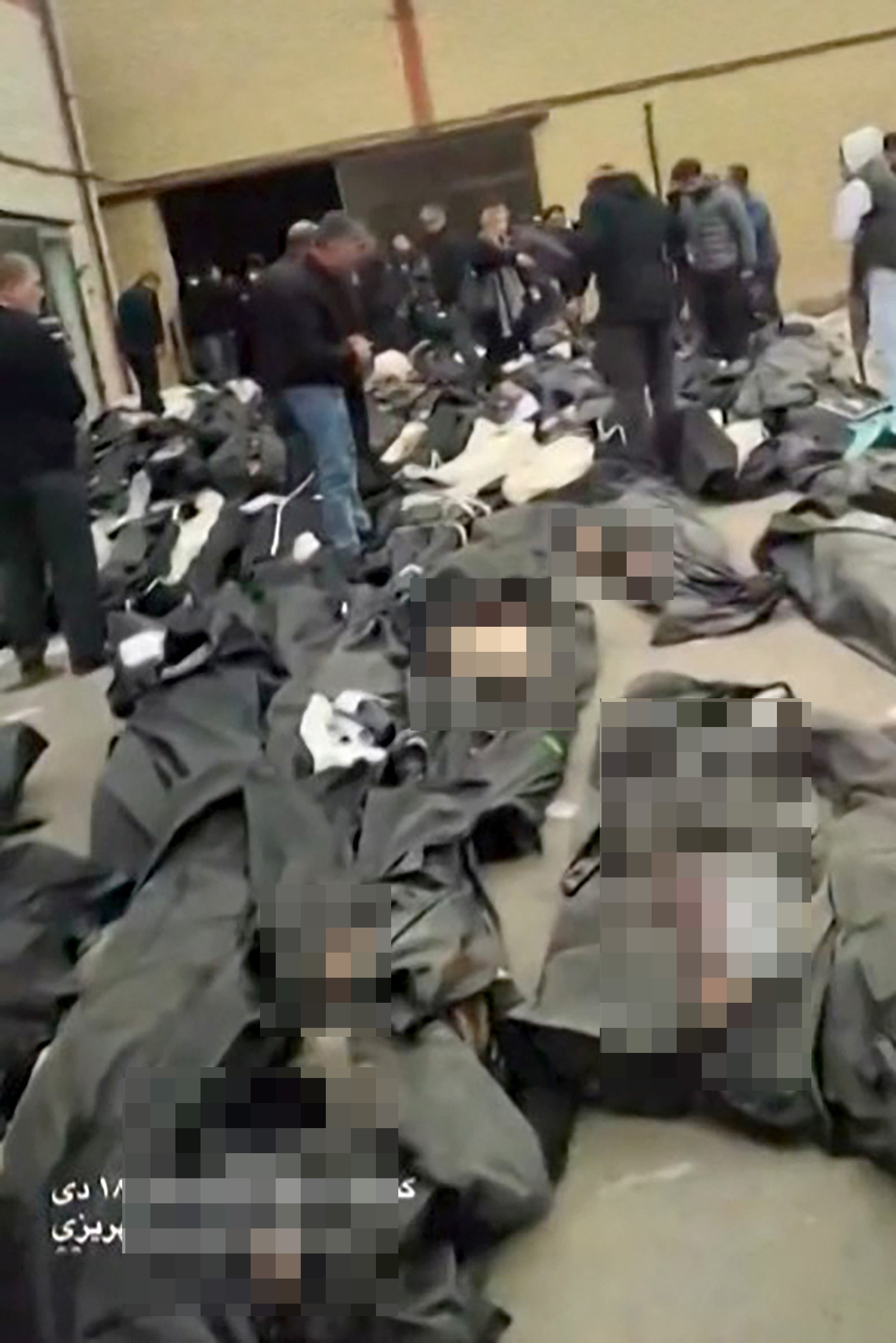 Video from Iran on Sunday showed dozens of bodies placed in body bags in the courtyard of a medical center in Tehran province for families to store.