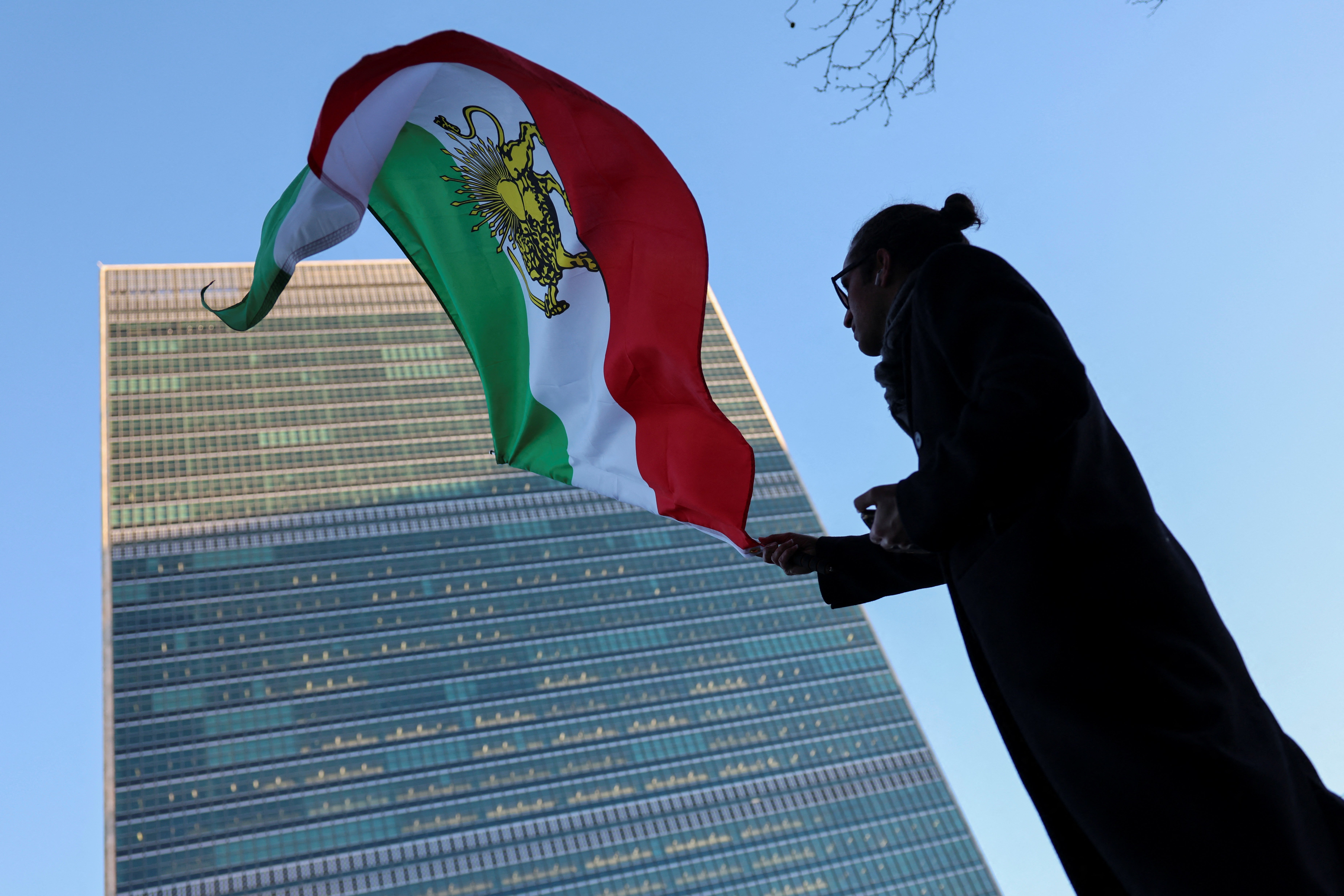 A protester waves an Iranian flag outside the United Nations Headquarters during the United Nations Security Council meeting on Iran in New York on January 15, 2026
