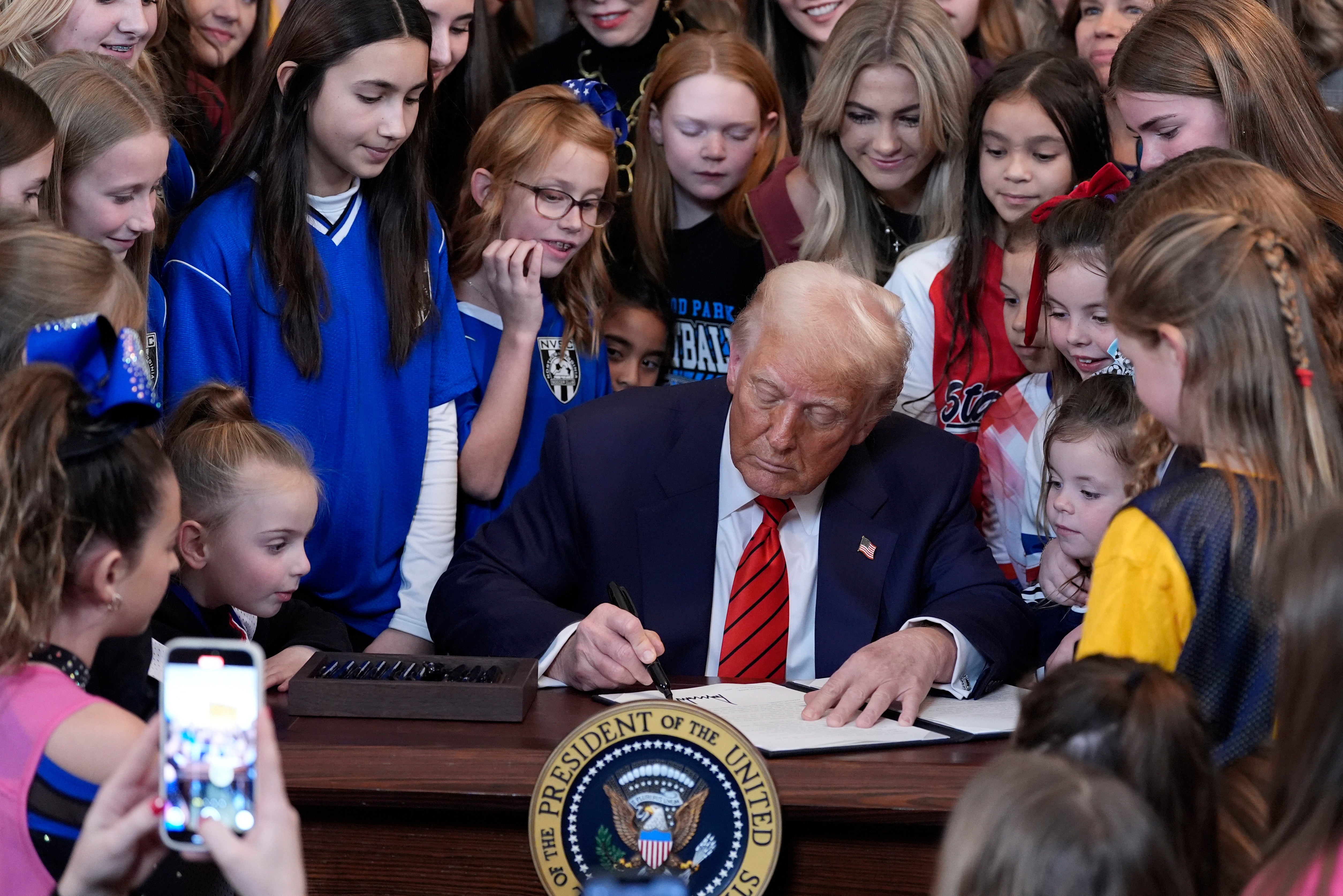President Donald Trump signs an executive order banning transgender female athletes from competing in women's or girls' sports events in the East Room of the White House on February 5, 2025 in Washington. (AP Photo/Alex Brandon, File)