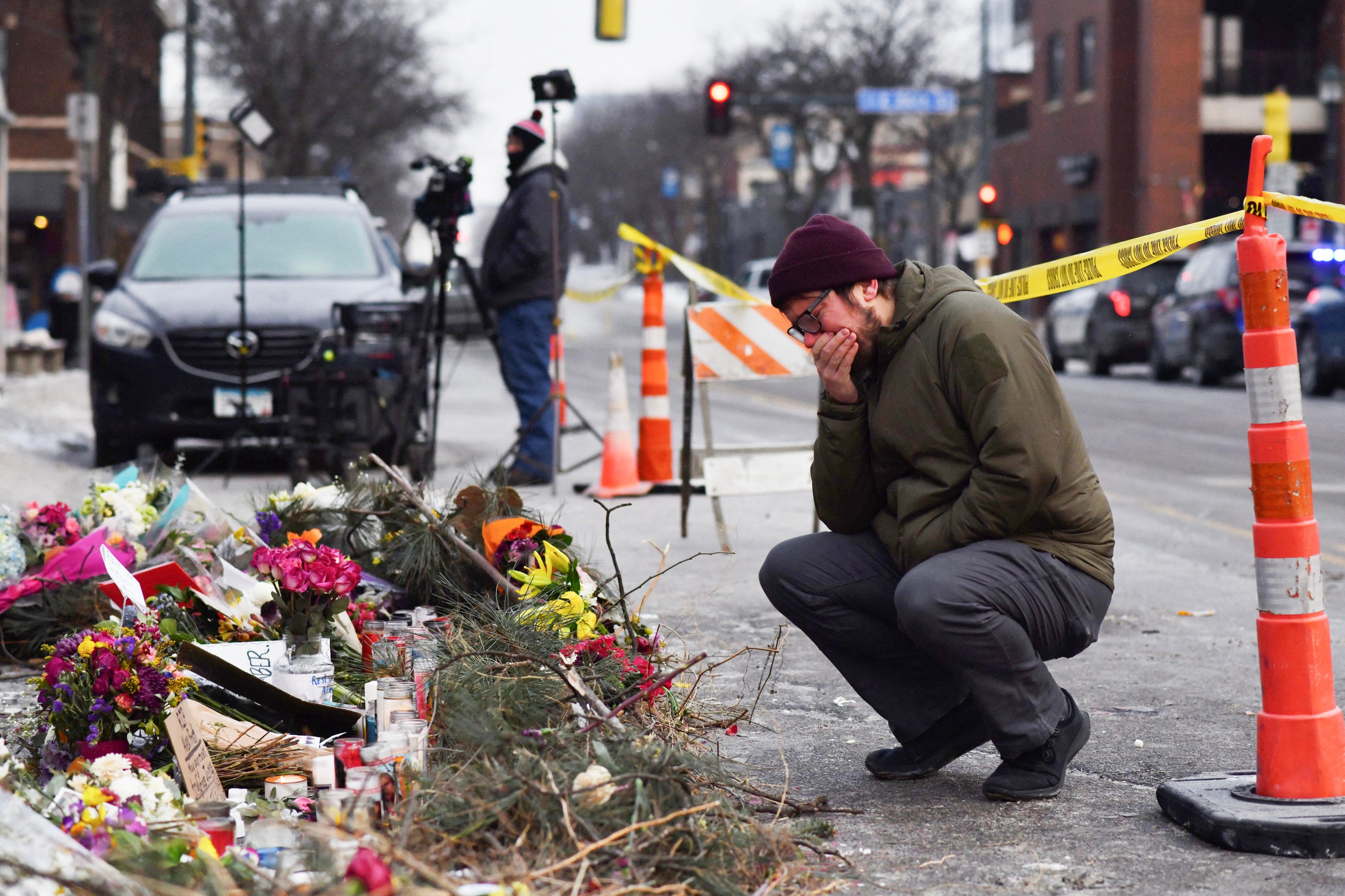 A mourner visits a makeshift memorial in the area where Alex Pretti was shot to death by federal immigration agents a day earlier in Minneapolis, Minnesota, on January 25.